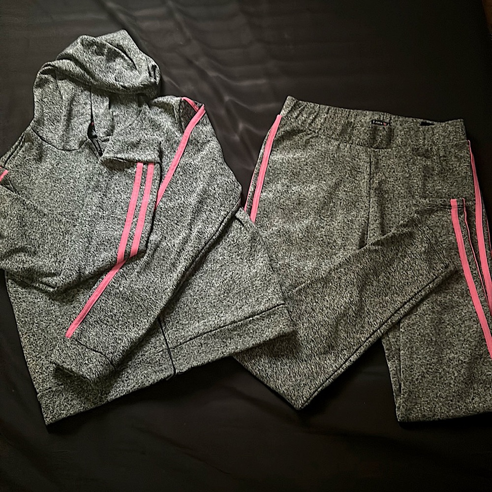 This is a outfit that is grey with 2 pink lines on the sides, The size is kids L